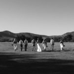 Bridal party walking in field