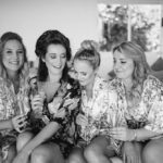 bride and bridesmaids getting dressed