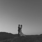 Bride and groom on hill