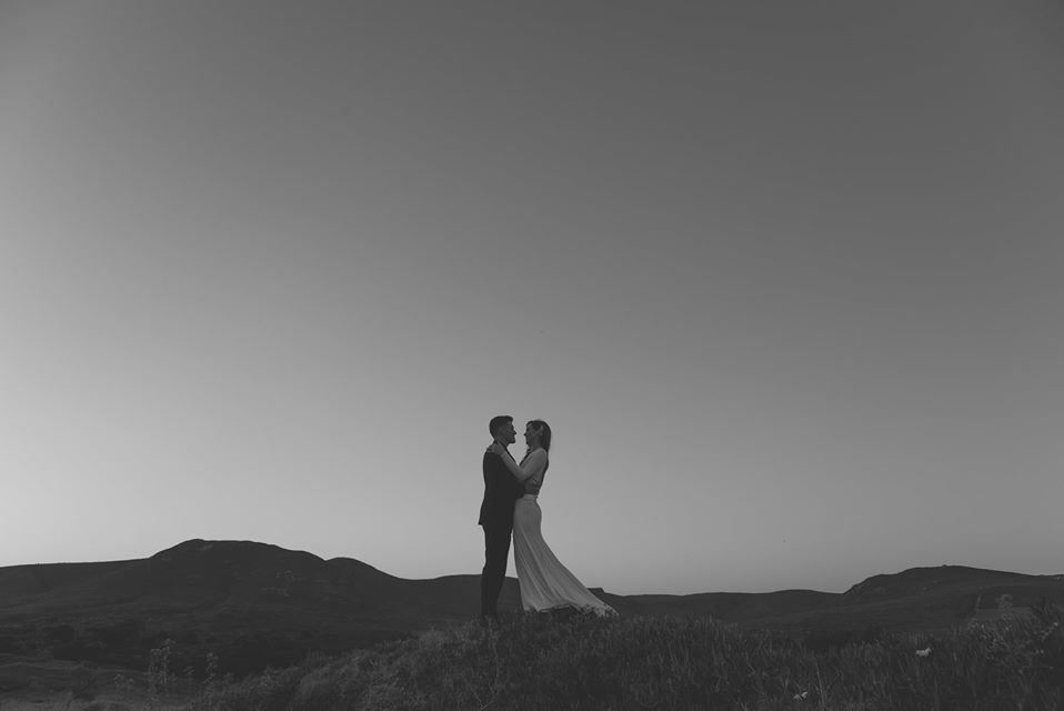 Bride and groom on hill