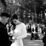 Groom putting ring on